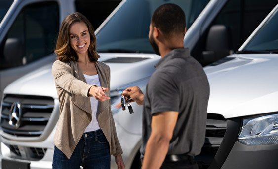 Mercedes-Benz Vans service technician handing keys to customer.