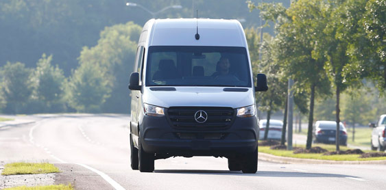 Woman in van checking navigation before long road trip.